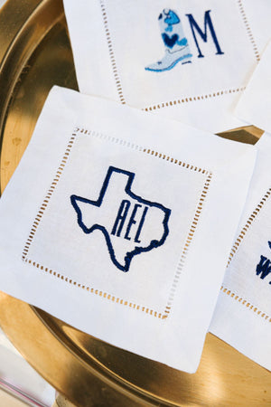 Embroidered cocktail napkins with Texas and boot designs
