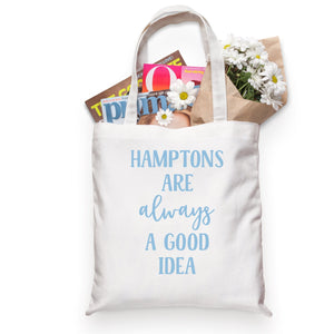 A cotton tote is customized with a light blue Hamptons design that says "Hamptons is always a good idea."