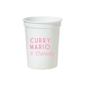 A white stadium cup is customized with a 3 name design in pink