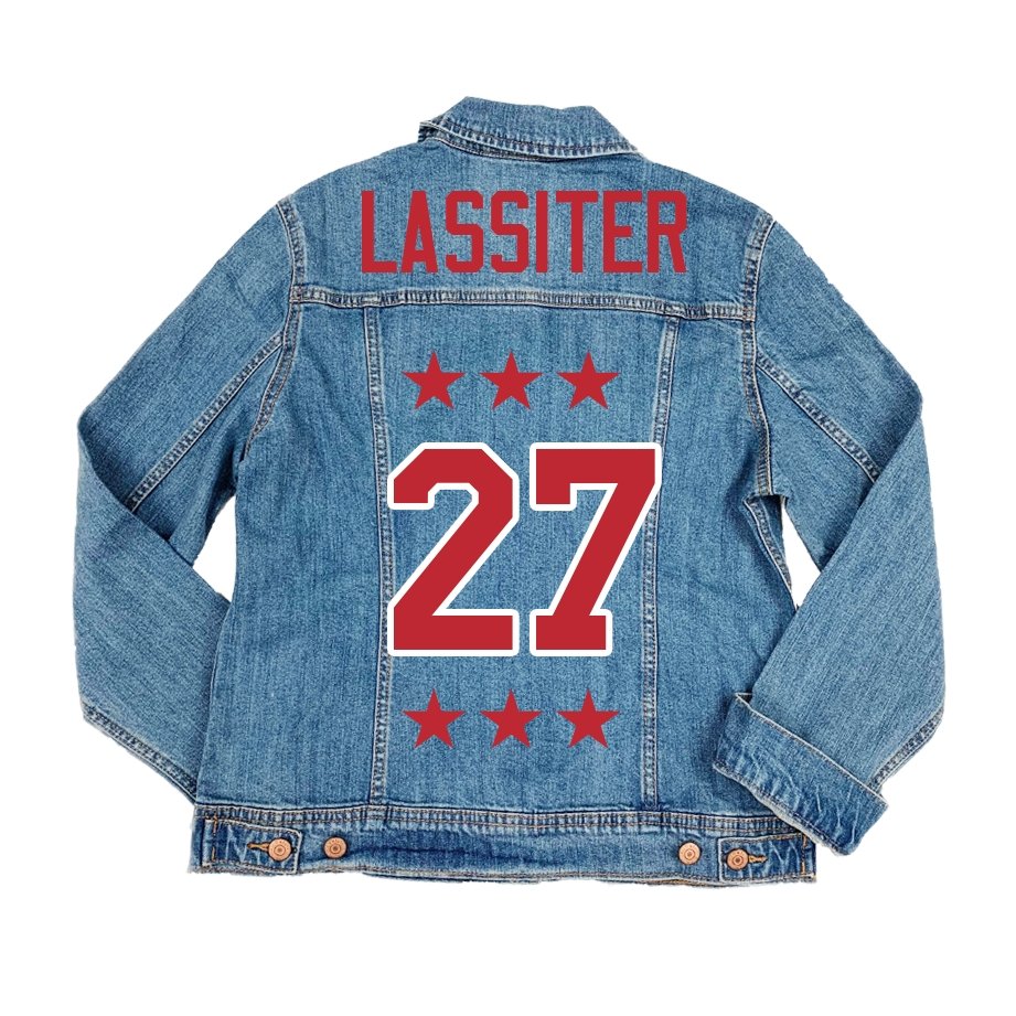 A denim jacket is customized with a red design featuring a custom number and last name.