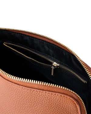 A tan leather pouch is opened to show the interior zipper pocket.