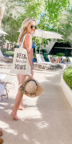 A woman wears a tote bag which says "Vegas Before Vows".