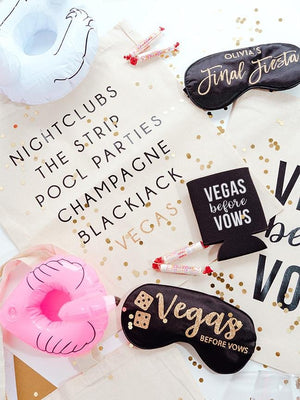 An assortment of products including a sleep mask, a tote bag, and a koozie are customized to take to Las Vegas.