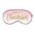 A pink sleep mask is customized with a gold design that says "Wake Me In Charleston".