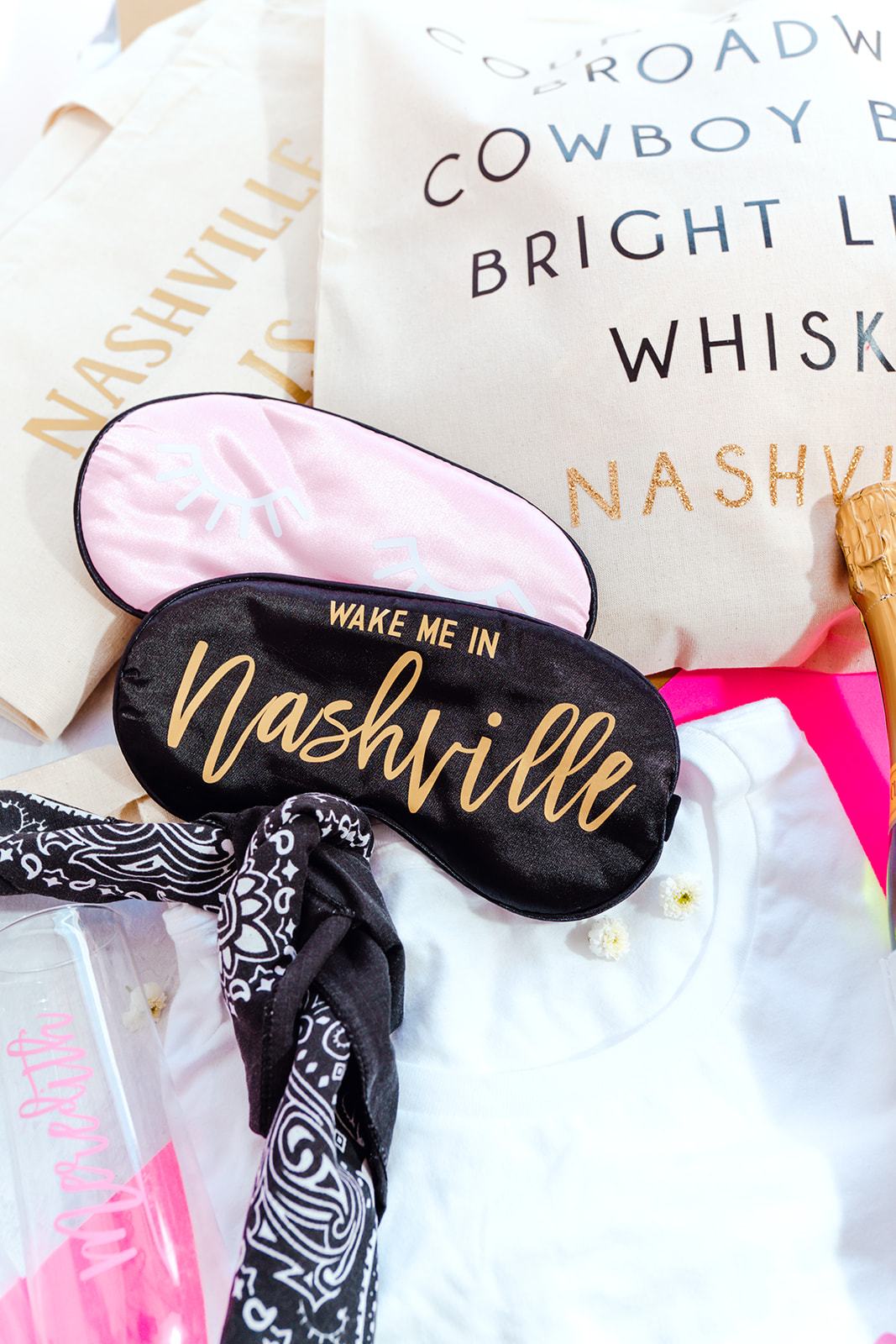A black sleep mask is customized with a gold design that says "Wake Me In Nashville".