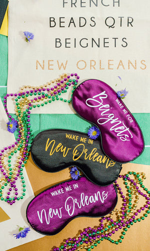 A group of sleep masks and tote bags are customized for a celebration in New Orleans.