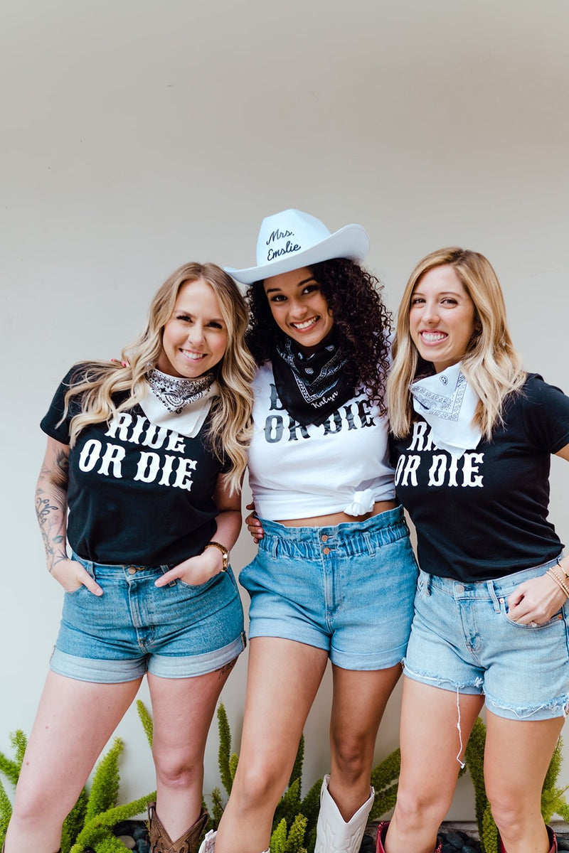 A group of three women celebrate a cowgirl bachelorette